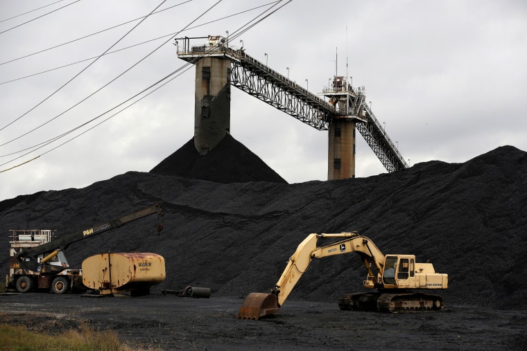 Image: Earth moving equipment sits by a coal pile at the Century Mine in Beallsville, Ohio