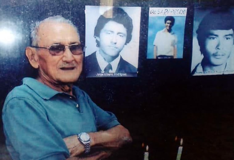 Image: Francisco Meliton Rodriguez Sequiera next to the monument where photos of victims of the disappeared are displayed in San Salvador