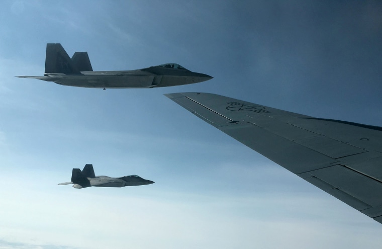 Image: U.S. Air Force F-22 stealth fighter jets receive fuel mid-air