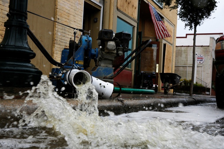 Image: Water is pumped out from store after Hurricane Florence in New Bern, N.C.