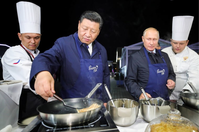 Image: Russian President Vladimir Putin and Chinese President Xi Jinping make pancakes