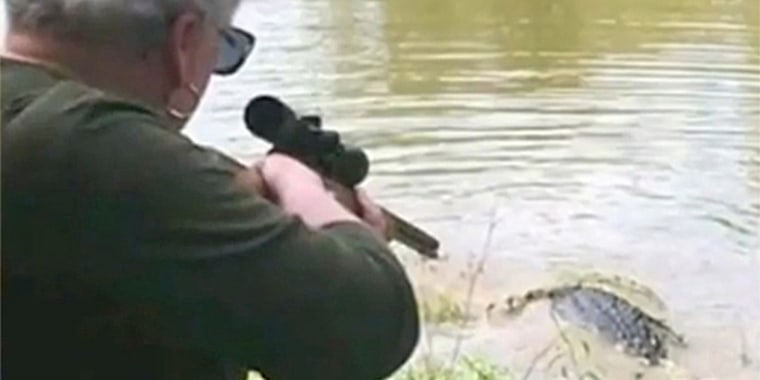 Mayor Judy Cochran takes aim at a gator. 