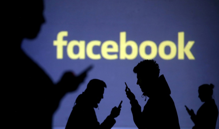 Image: Silhouettes of mobile users next to a screen projection of the Facebook logo