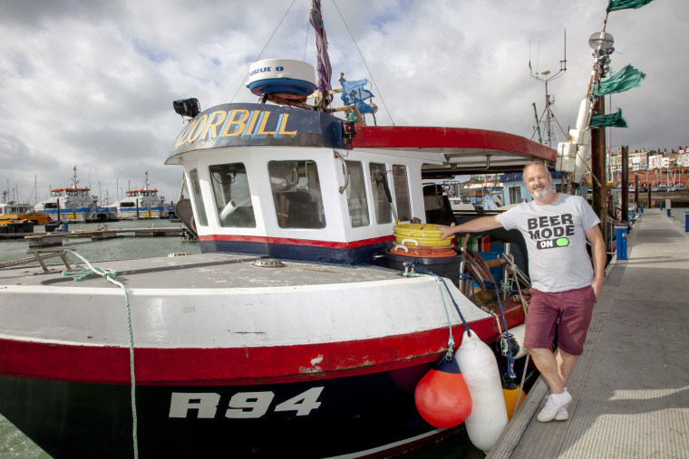 Image: Fisherman Steve Barratt posed with his boat, The Razorbill, in Margate, England