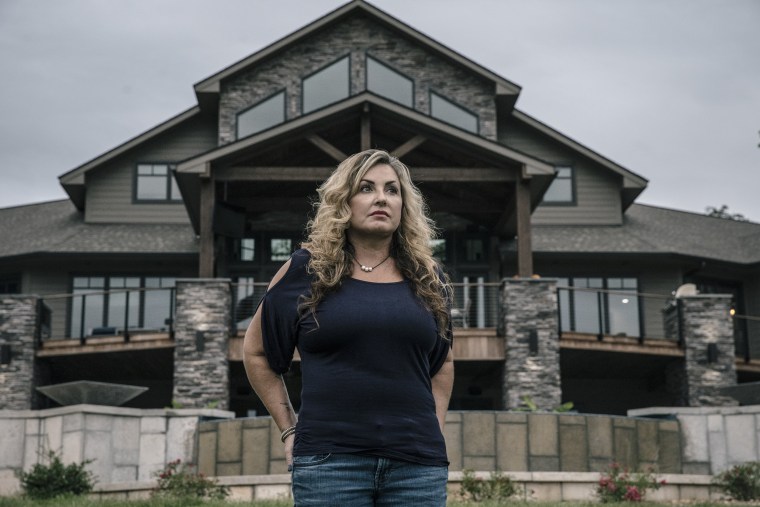 Image: Heather Melton stands for a portrait at the home she built with her husband Sonny Melton