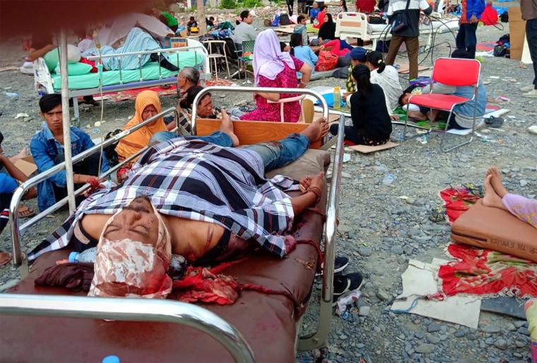 Image: Survivors rest on trollies outside a hospital in Palu, Indonesia.