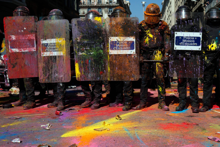 Image: Catalan police 'Mossos D'Esquadra' officers covered in paint.