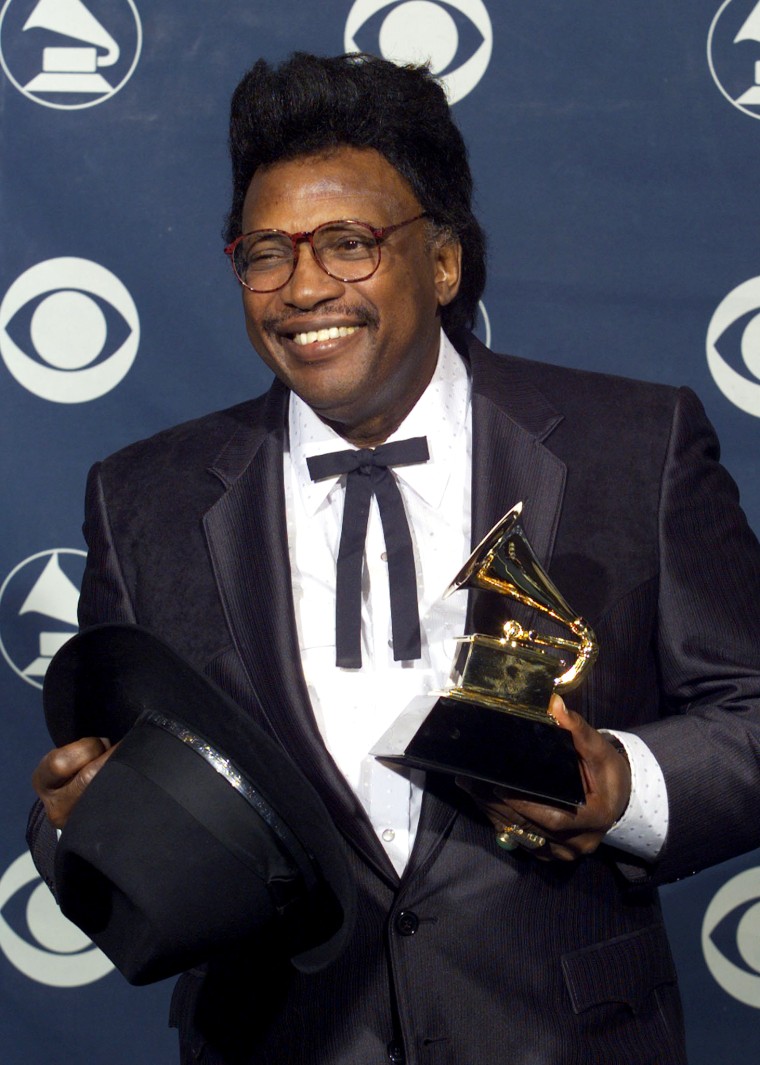 Singer Otis Rush poses with the Grammy Award