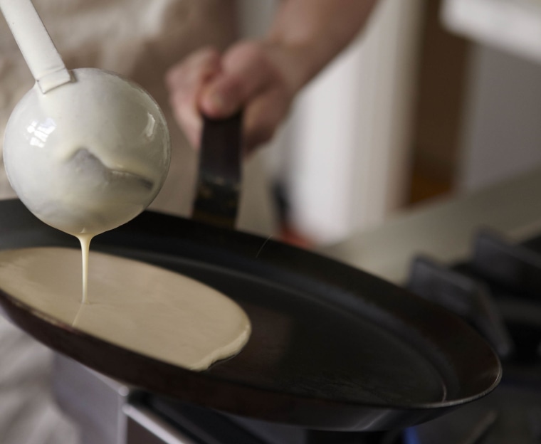 Place crepe batter in the pan.