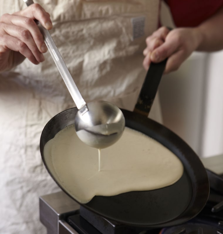Tilt the crepe batter in the pan.