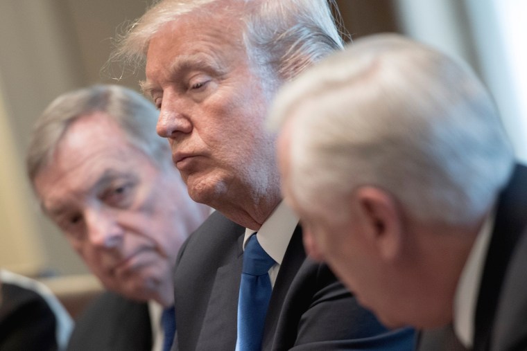 Image: President Donald Trump is flanked by Senator Dick Durbin and Congressman Steny Hoyer during a meeting with bipartisan members of the Senate on immigration at the White House in Washington, DC, on Jan. 9, 2018.