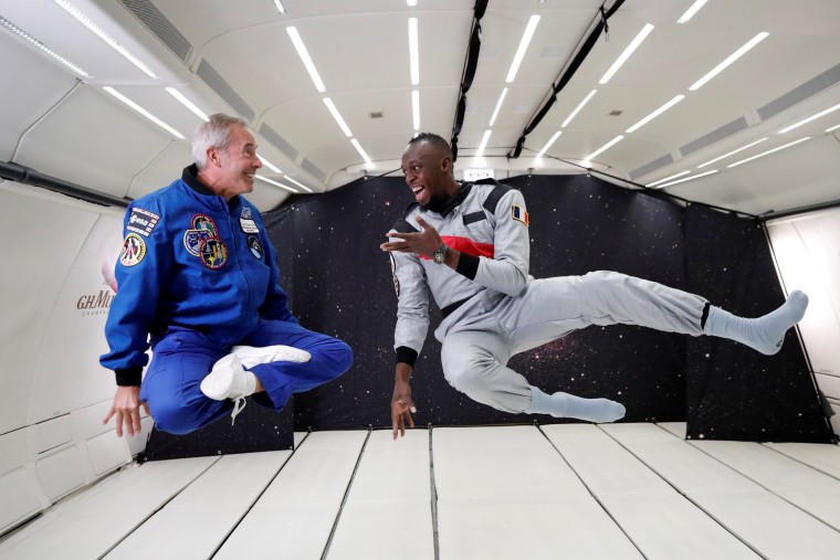 Image: Retired sprinter Usain Bolt and French astronaut Jean-Francois Clervoy enjoy zero gravity conditions during a flight in a specially modified plane above Reims