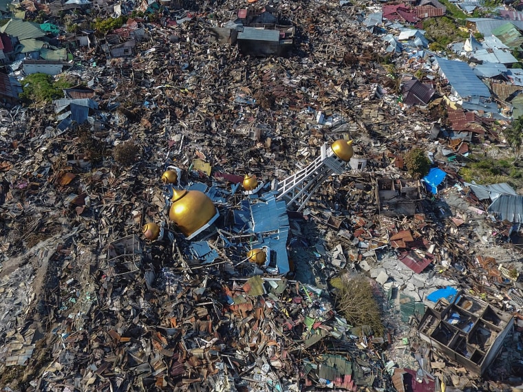 Rescues and mass graves: Scenes of devastation in hard-hit