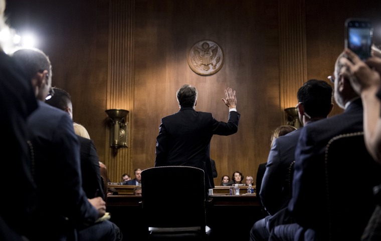 Image: Supreme Court nominee Judge Brett Kavanaugh is sworn in before testifying during the Senate Judiciary Committee