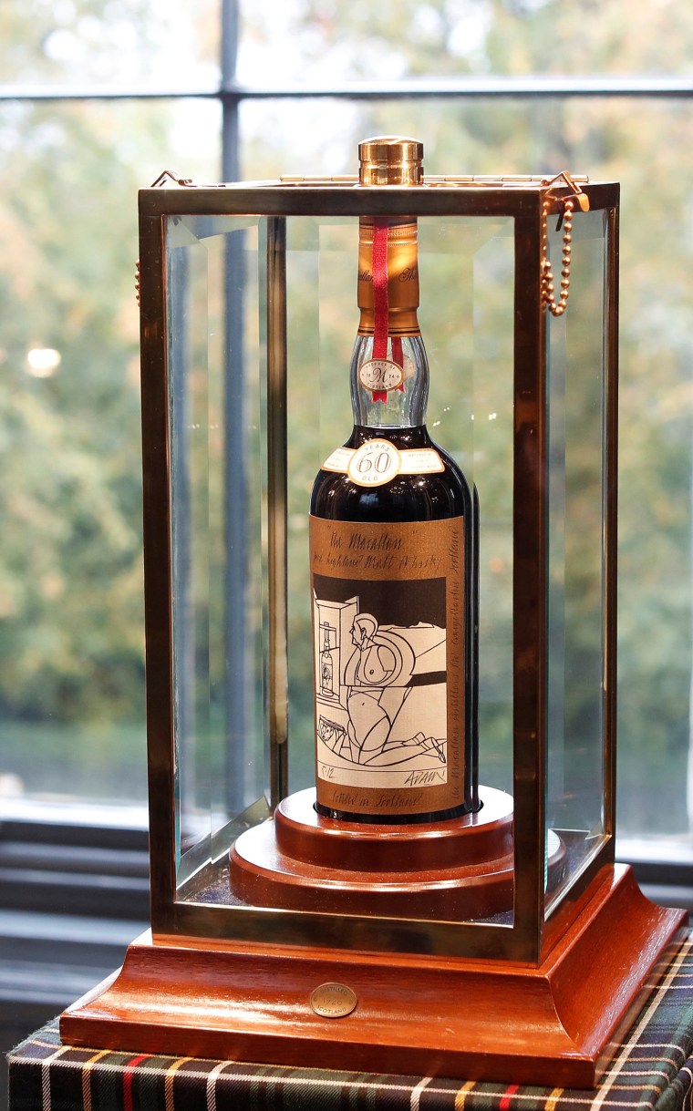Image: A 60-year old The Macallan Valerio Adami 1926 is seen in a glass case after it was auctioned for a record amount at Bonhams in Edinburgh, Scotland