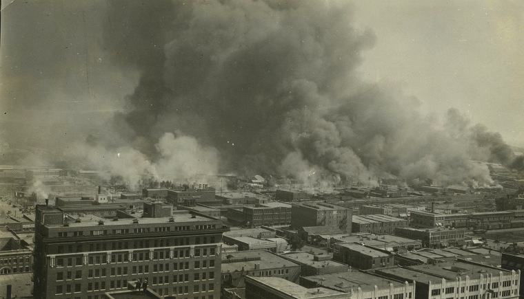 Image: Smoke rises over Tulsa's Greenwood District during race riots which left 300 blacks dead and hundreds more wounded in a span of 18 hours, on June 1, 1921.