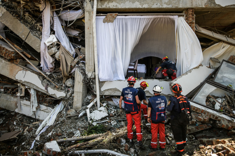 French members of the International Emergency Firefighters prepare to enter the badly damaged Mecure hotel