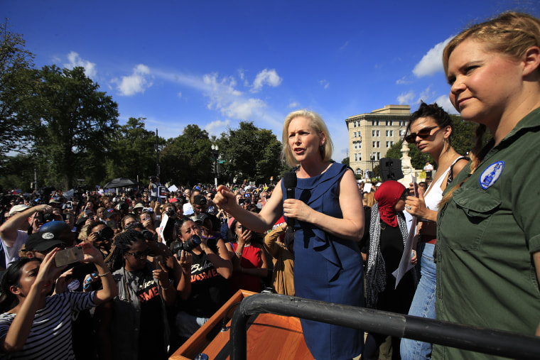 Sen. Kirsten Gillibrand, D-N.Y., with actor and comedian Amy Schumer, right, speaks at a rally against Brett Kavanaugh at the Supreme Court on Thursday.