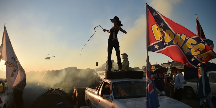A woman cracks a bull whip on top of her truck at the annual Deni Ute Muster in Deniliquin, Australia, on Sept. 29.