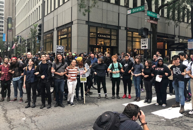 Chicago protesters lock arms to shut down a busy downtown intersection during demonstrations following Office Jason Van Dyke's guilty verdict in Chicago on Oct. 5, 2018.