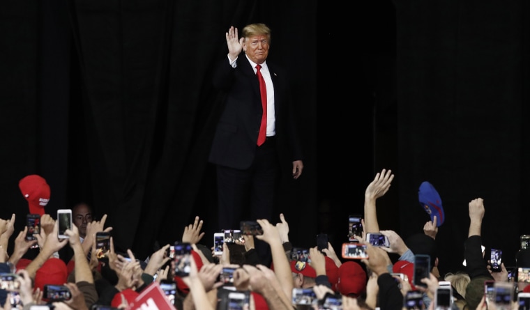 President Donald Trump waves to the crowd at a rally in Topeka
