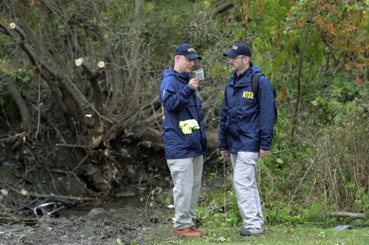 Members of the National Transportation Safety Board work at the scene of yesterday's fatal crash, in Schoharie