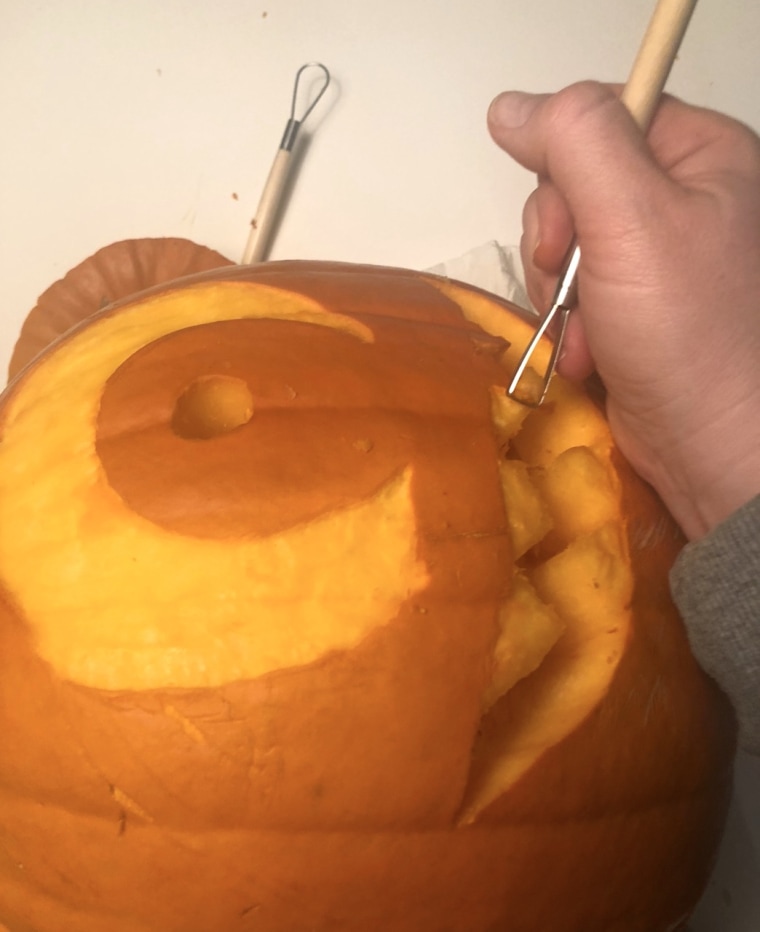 We used the scraper tool to peel away the pumpkin skin--kind of like a dental hygienist--and the pro move was easier than we thought!