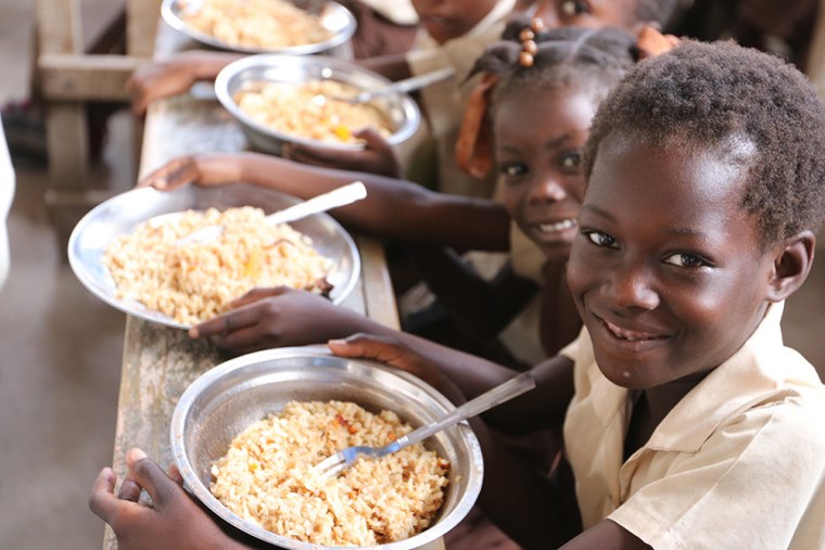 Children in Haiti receive meals provided by Rise Against Hunger. 
