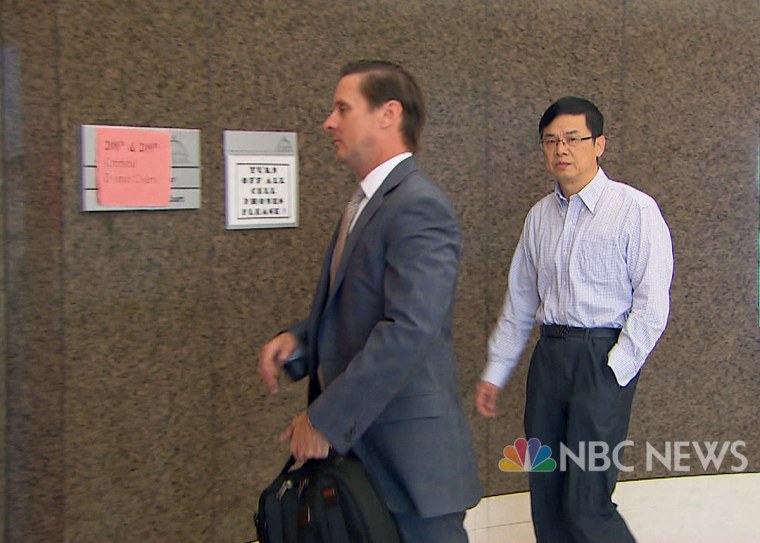 Keping Xei with his attorney Nathan Mays in Houston on Oct. 3. 