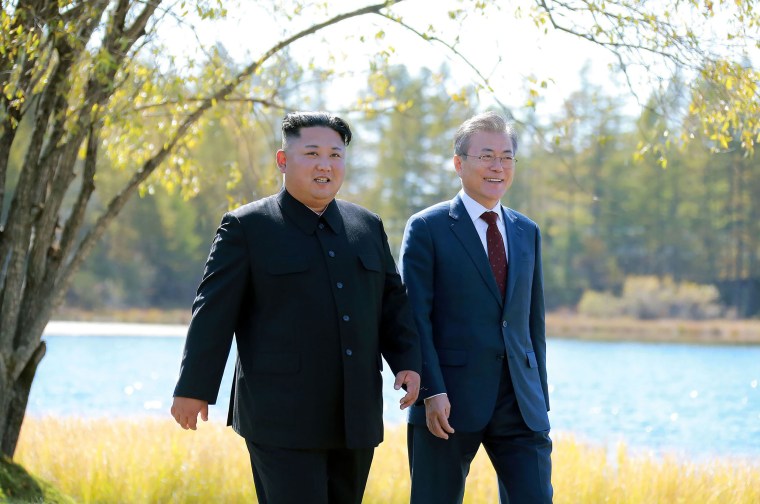 Image: North Korea's leader Kim Jong Un (L) and South Korean President Moon Jae-in (R) walking together during a visit to Samjiyon guesthouse