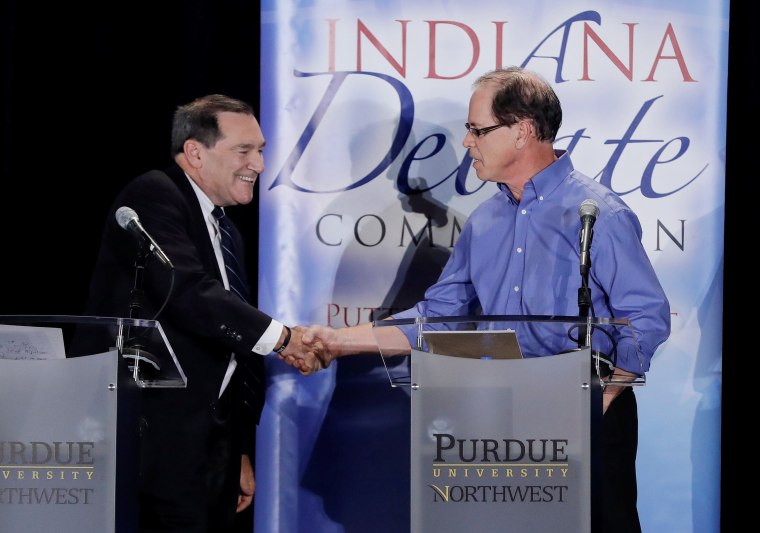 Image: Democratic U.S. Sen. Joe Donnelly shakes hands with Republican former state Rep. Mike Braun following a U.S. Senate Debate in Westville Indiana