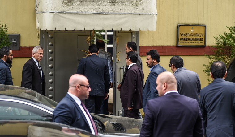 Image: Saudi officials arrive at Saudi Arabia's consulate in Istanbul on Tuesday as demonstrators gather to protest the Khashoggi's disappearance