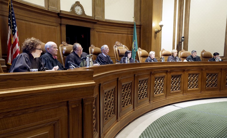 Justices on the Washington state Supreme Court listen during a hearing in Olympia, Washington on Sept. 7, 2016.