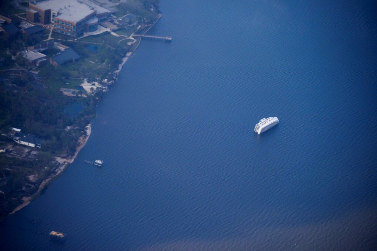 A capsized boat is seen during a U.S. Coast Guard aerial assessment of coastal areas affected by Hurricane Michael near Apalachicola