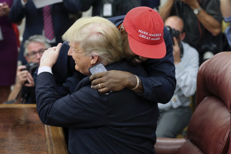 President Donald Trump hugs rapper Kanye West during a meeting in the Oval office on Oct. 11, 2018.