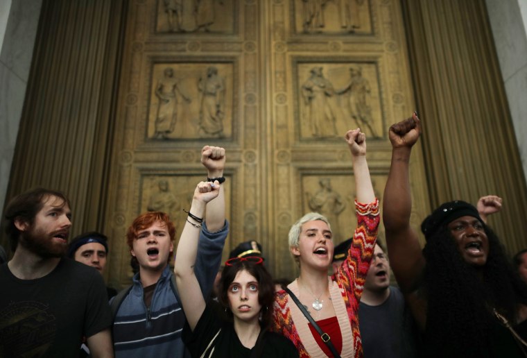 After overrunning police barricades, protesters chant as they block the doors to the U.S. Supreme Court while demonstrating against the confirmation of Associate Justice Brett Kavanaugh on Oct. 6, 2018. The protesters marched up to the doors of the court as Kavanaugh was inside taking his oath.