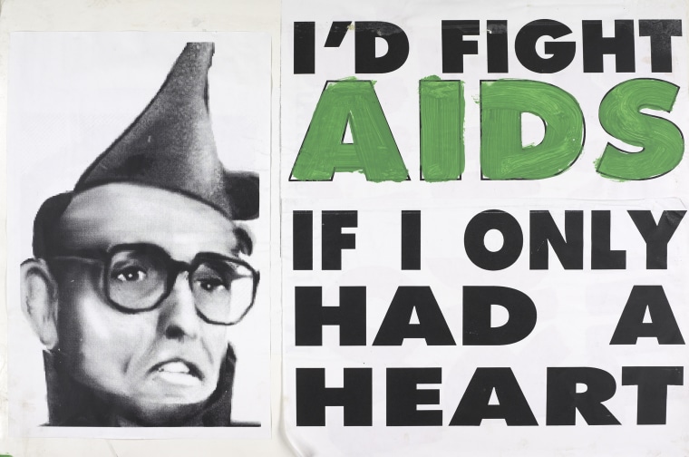 A sign that reads" I'd fight AIDS if only I had a heard next to a photo of Rudy Giuliani