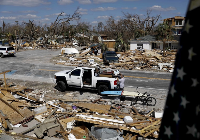 William Johnson helps pack up a friend's belongings as he returns to his damaged home from hurricane Michael in Mexico Beach