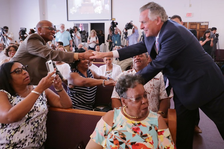 Image: Virginia Gov. Terry McAuliffe greets churchgoers during a worship service at Mt. Zion First African Baptist Church