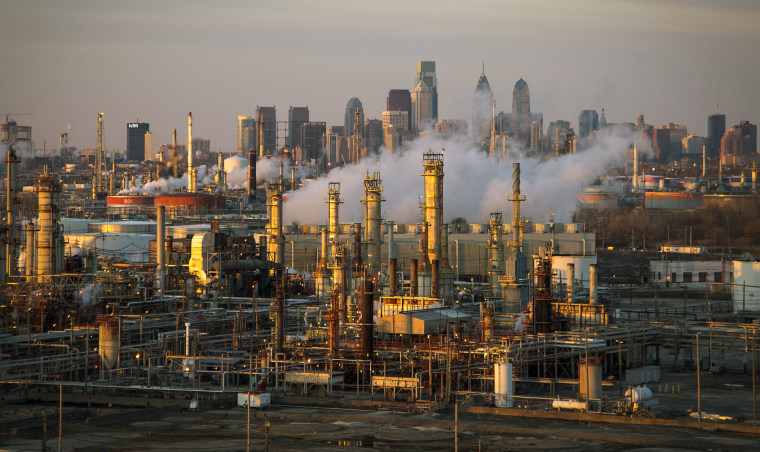 The Philadelphia Energy Solutions oil refinery owned by The Carlyle Group is seen at sunset in front of the Philadelphia skyline March 24, 2014.