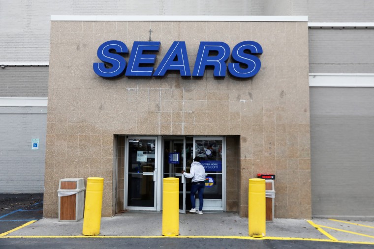Image: A person walks into a Sears store in Brooklyn, New York