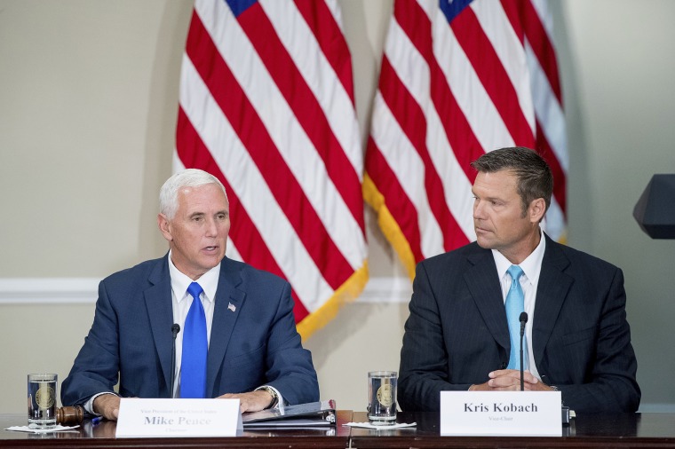 Vice President Mike Pence accompanied by Vice-Chair Kansas Secretary of State Kris Kobach speaks during the first meeting of the Presidential Advisory Commission on Election Integrity at the Eisenhower Executive Office Building on the White House complex on July 19, 2017.