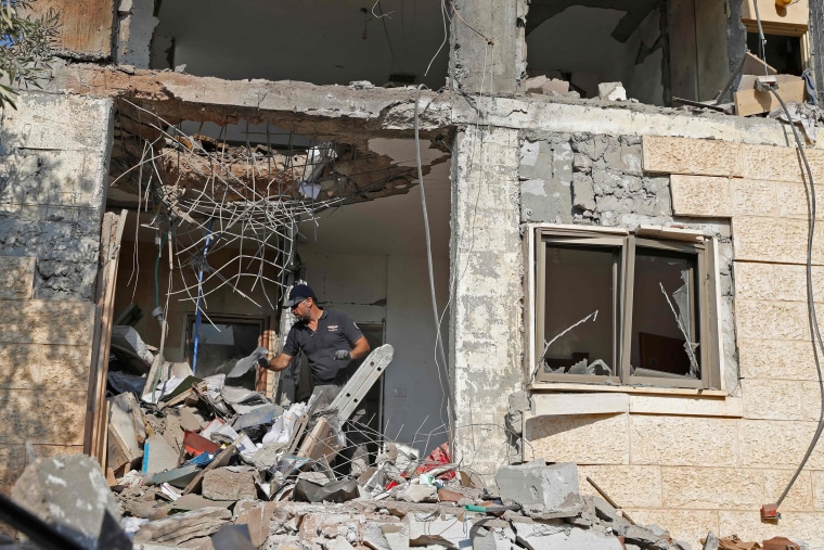 Image: An Israeli sapper checks a house after it was hit by a rocket fired from the Hamas-run Palestinian Gaza Strip,