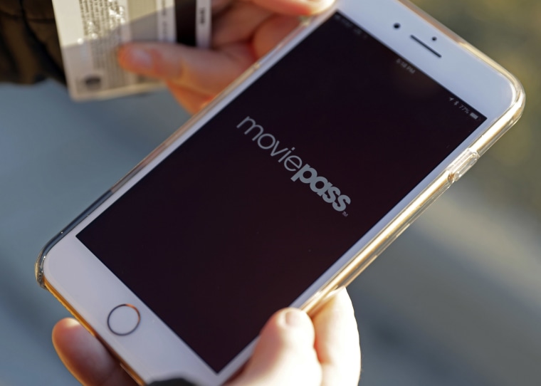 Image: Cassie Langdon uses to her phone to launch the MoviePass app to see what movies are available at AMC Indianapolis 17