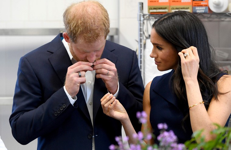 Image: Britain's Prince Harry and and his wife Meghan, Duchess of Sussex sample ingredients used in native food at the Charcoal Lane Mission Australia social enterprise restaurant in Melbourne on Oct. 18, 2018.