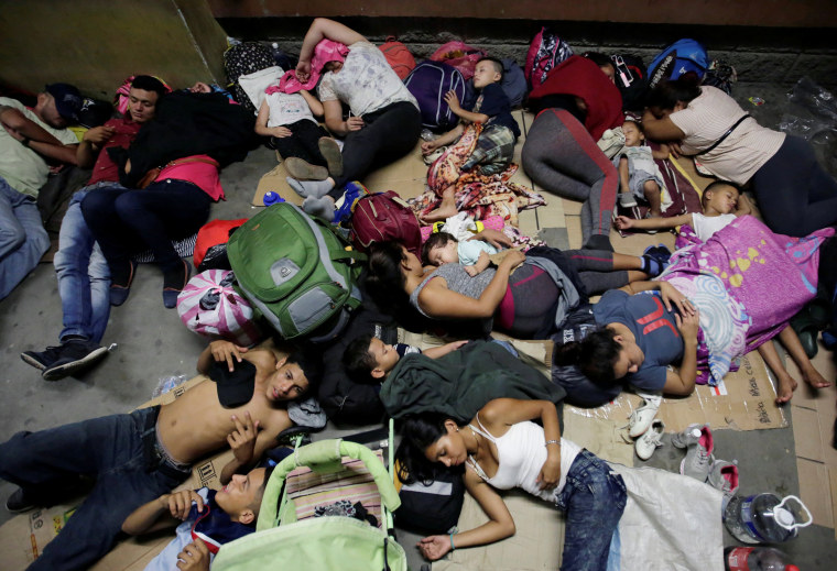 Hondurans fleeing poverty and violence, rest before moving in a caravan toward the United States, outside the bus station in San Pedro Sula