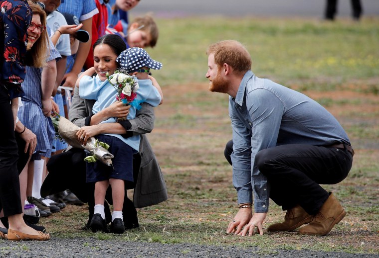 Image: Britain's Prince Harry and Meghan, Duchess of Sussex, interact with Luke Vincent, 5, after arriving at Dubbo airport, Dubbo