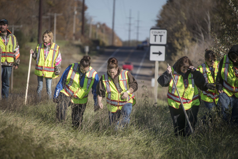 Image: A group of volunteers searched the ditches along highway 8, Thursday, Oct. 18, 2018, in Barron, Wis., near the home where 13-year-old Jayme Closs lived with her parents James, and Denise.