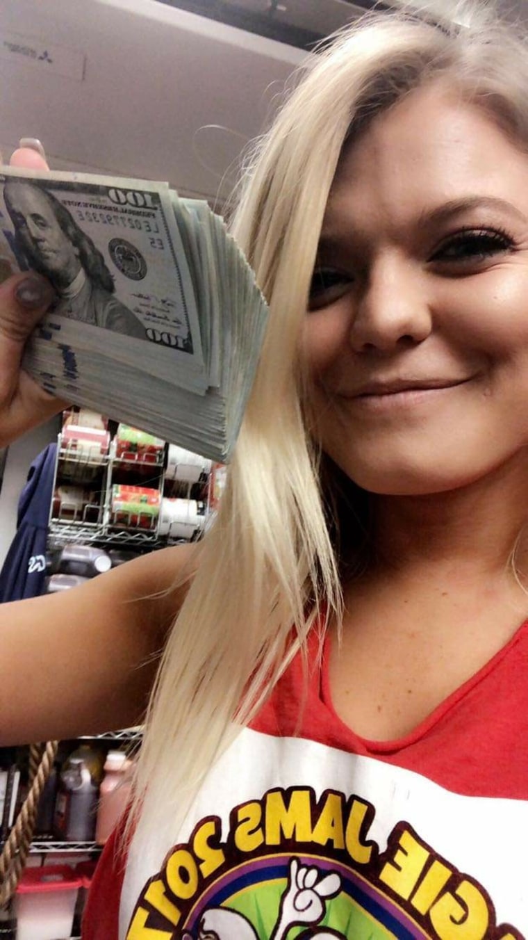 Alaina Cluster posing with her $10,000 tip.