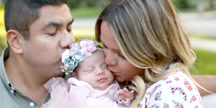 Lauren and Margarito Torres with their newborn daughter, Isa.
